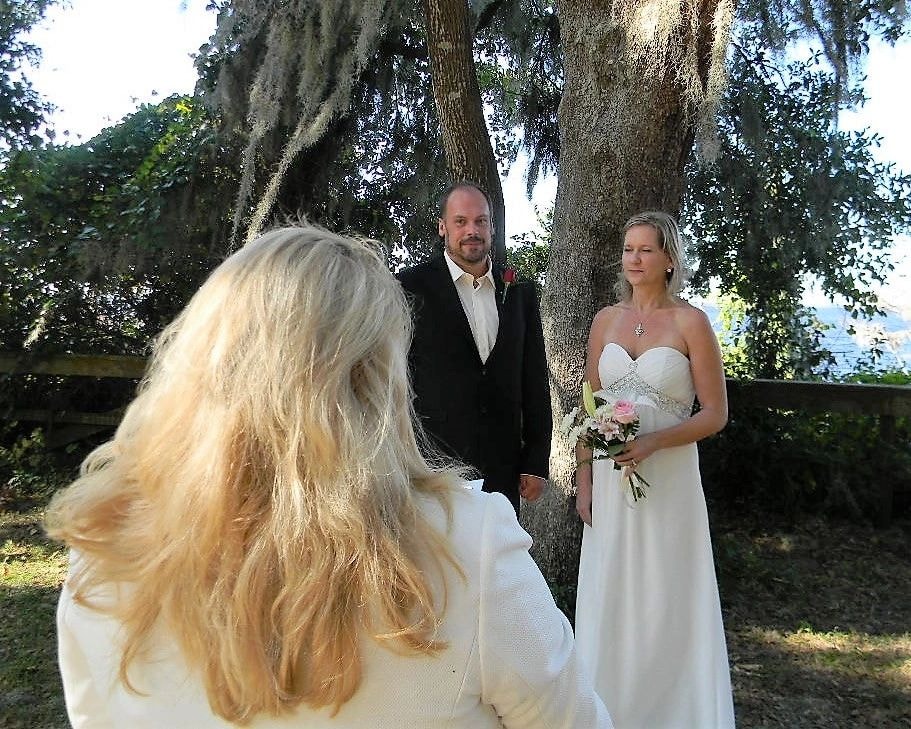 Outdoor wedding ceremony under moss-draped tree
